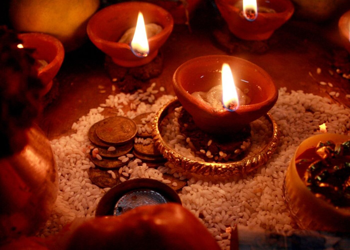 Rows of lit oil lamps (diyas) arranged for Diwali