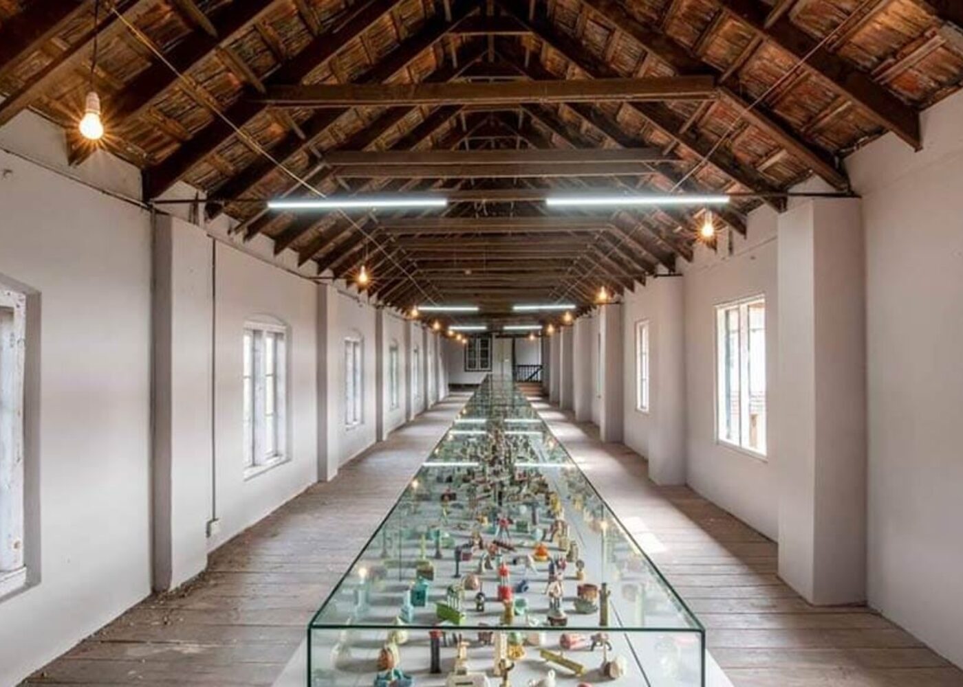 A contemporary art installation displayed inside a heritage warehouse space at the Kochi-Muziris Biennale